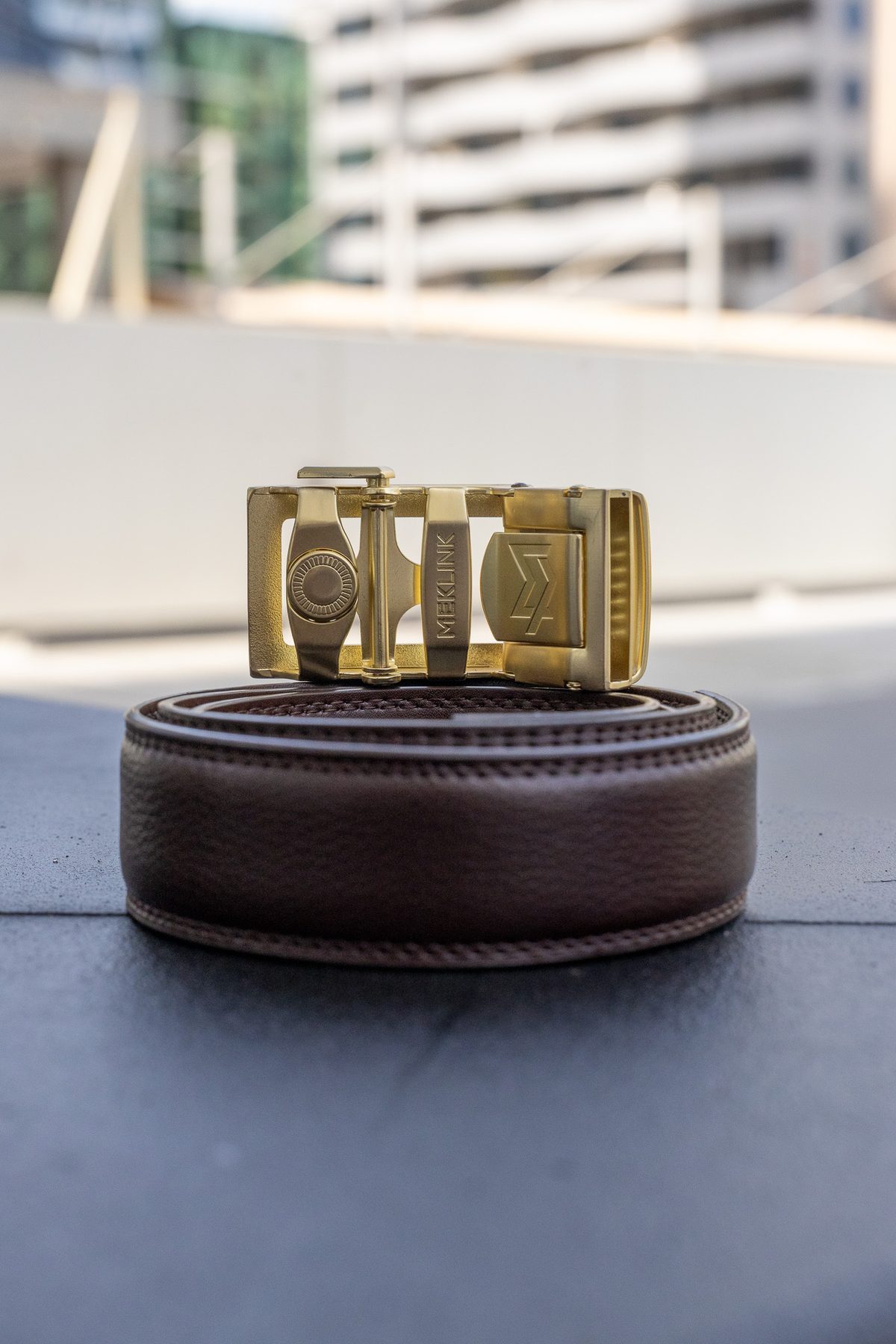 Brown leather MEKLINK with gold buckle, Dubai rooftop
